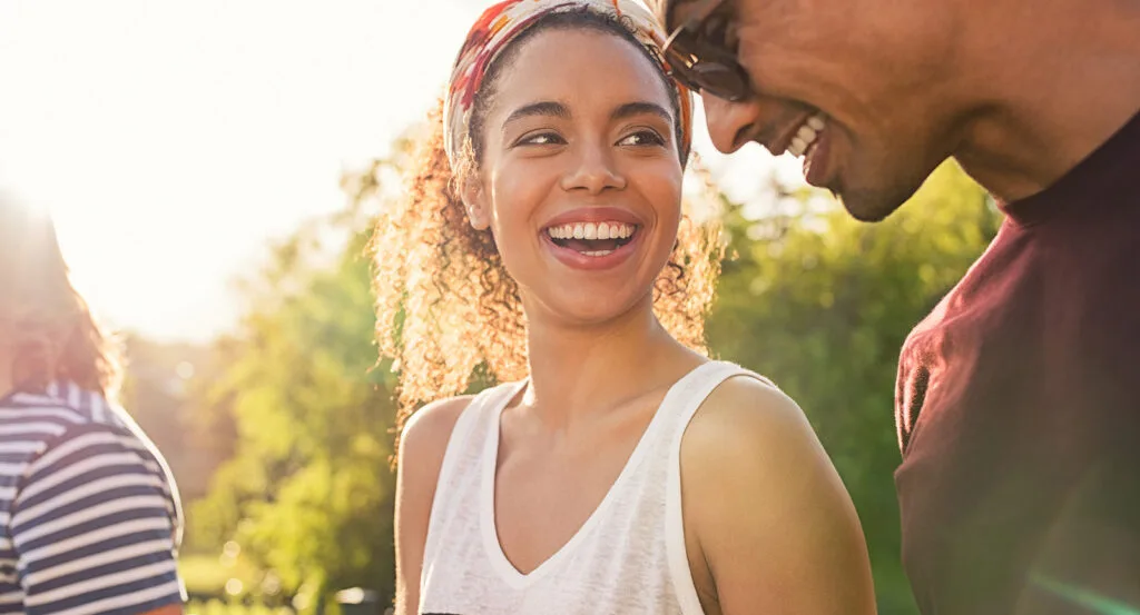 Cheerful woman holding a smartphone
