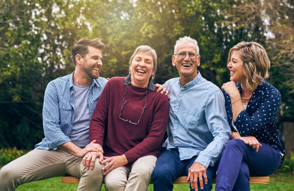Multigenerational family laughing together outdoors